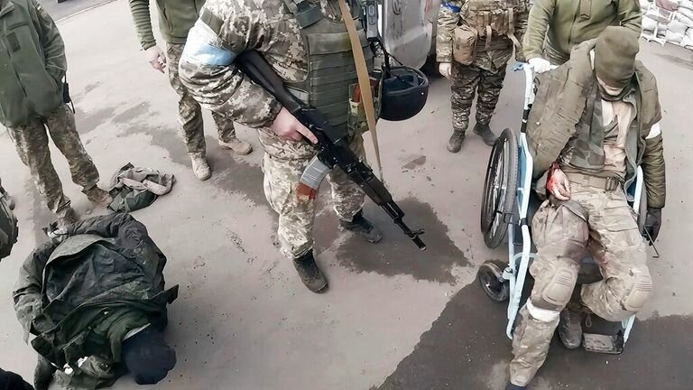 Two wounded Russian servicemen, left and right, arrived at the hospital for treatment in Mariupol