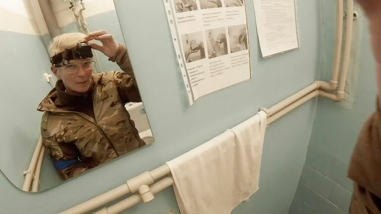 Yulia Paevskaya looks in the mirror and turns off the camera in Mariupol on February 27